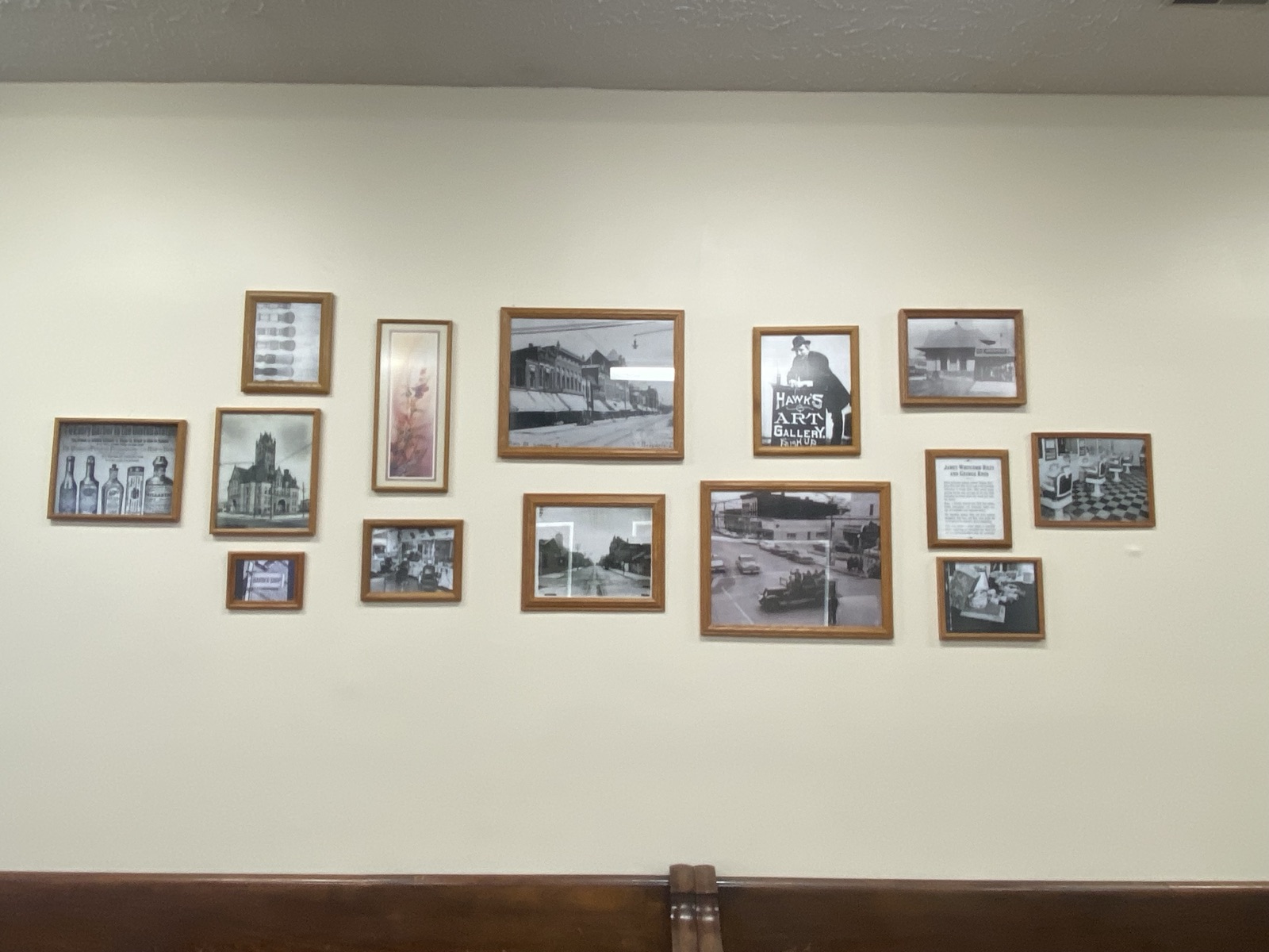 A wall of framed historic Greenfield photographs inside the shop